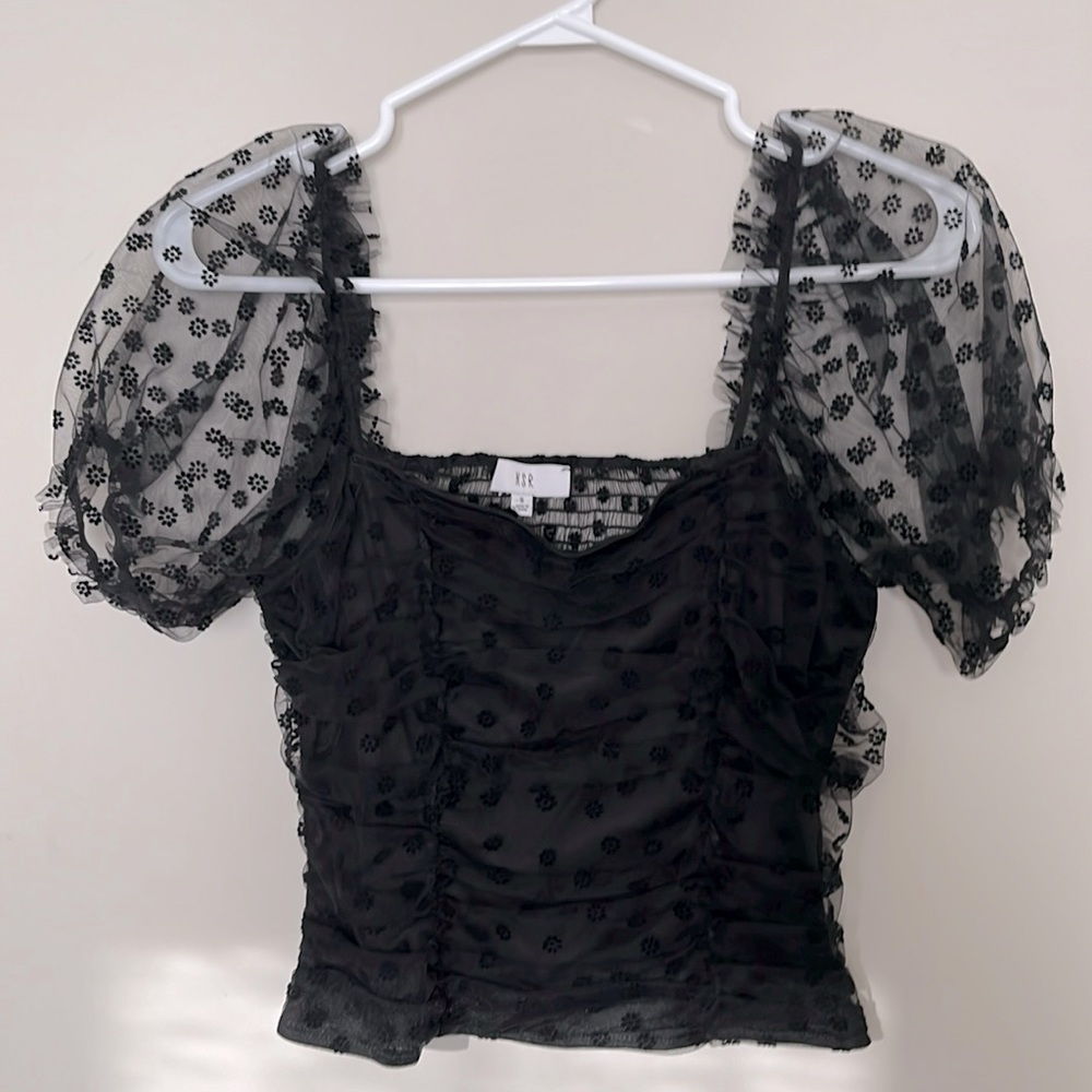 Size small black top with lace sleeves.